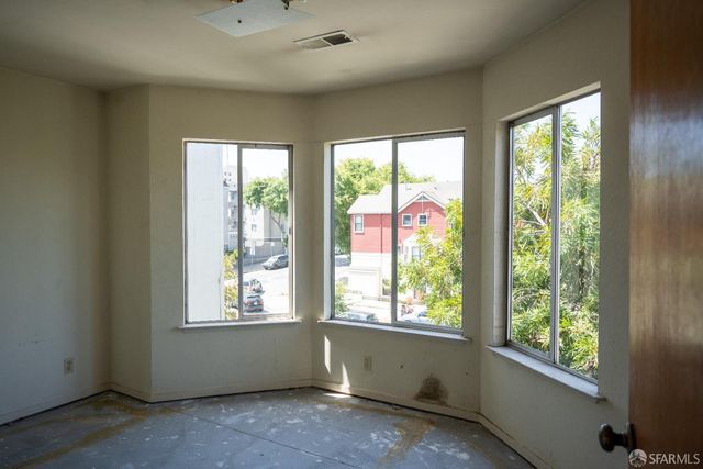 a room with a large window and bed