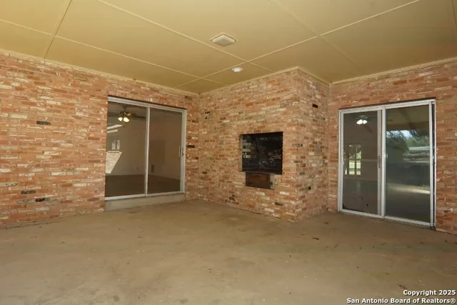 a view of an empty room with a fireplace