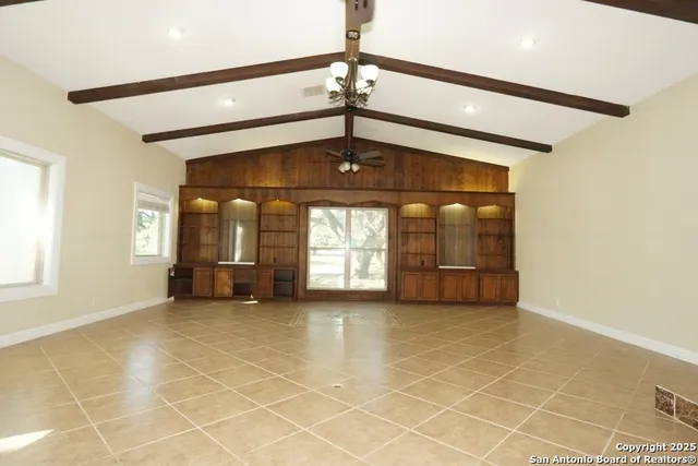 a view of a livingroom with a ceiling fan and window