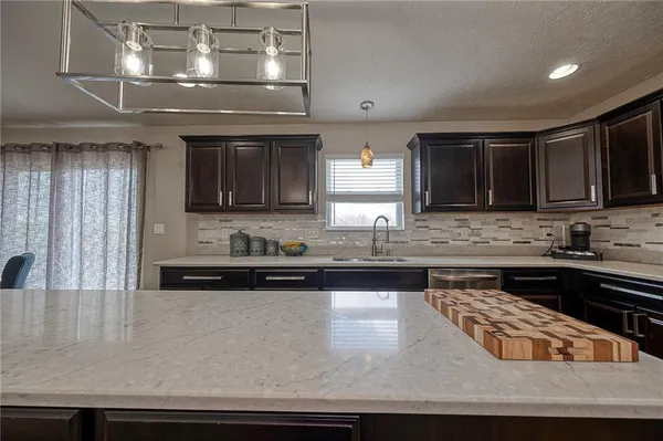 a kitchen with stainless steel appliances granite countertop a stove and a sink