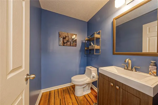 a bedroom with a bed and a flat tv screen on dresser