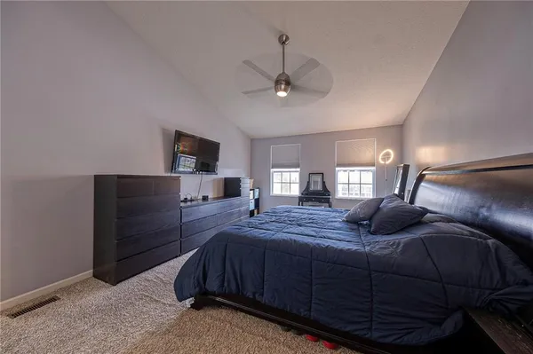 a bedroom with a bed dresser and a window