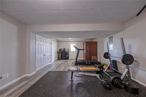 a view of a house with a yard and sitting area