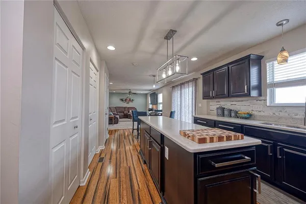a kitchen with a sink stove and cabinets