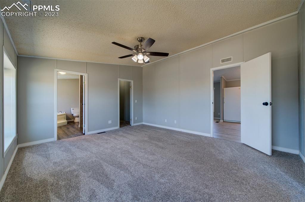 33220 Fossinger Road Yoder, CO 80864 - Photo 13 of 21 a view of a big room with chandelier fan and a bathroom