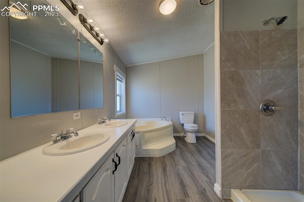 33220 Fossinger Road Yoder, CO 80864 - Photo 14 of 21 a bathroom with a double vanity sink toilet and a mirror