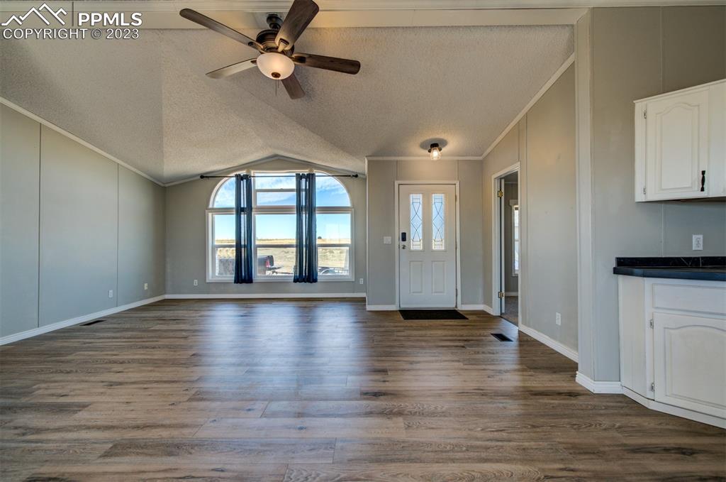 33220 Fossinger Road Yoder, CO 80864 - Photo 2 of 21 a view of an empty room with window and wooden floor