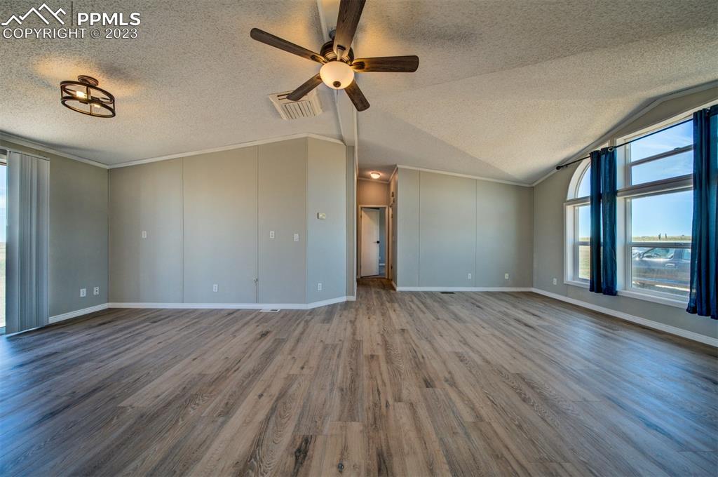 33220 Fossinger Road Yoder, CO 80864 - Photo 5 of 21 a view of an empty room with a window and wooden floor