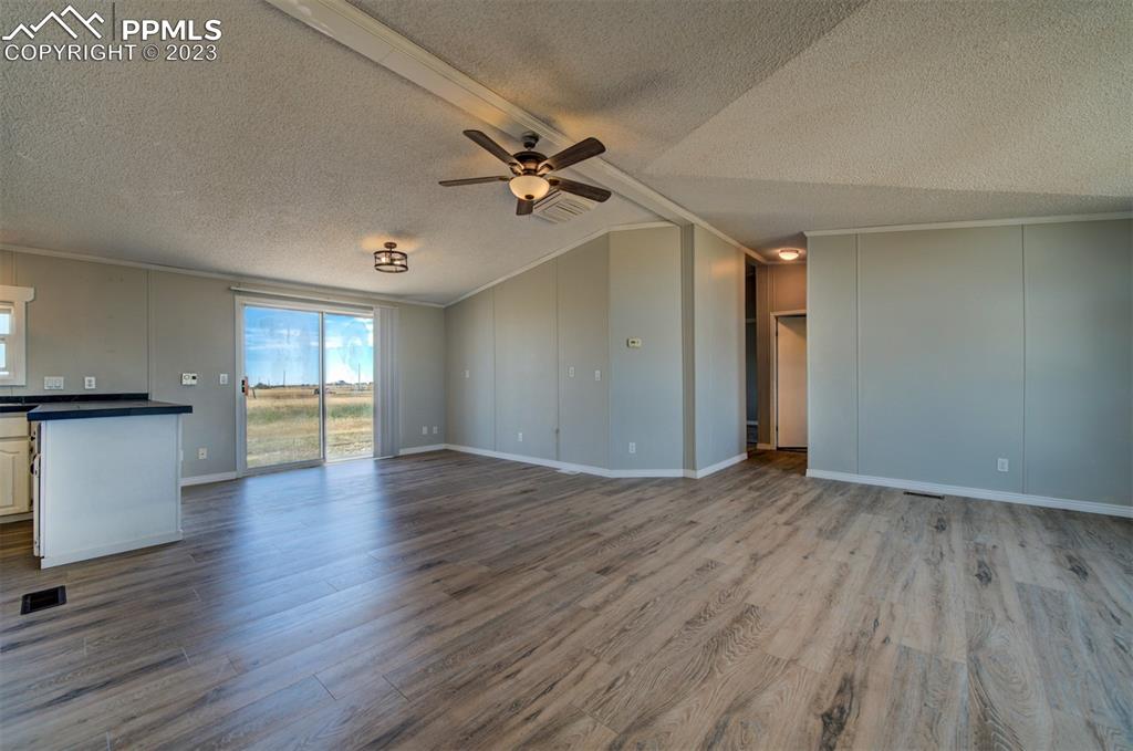 33220 Fossinger Road Yoder, CO 80864 - Photo 6 of 21 an empty room with wooden floor and windows
