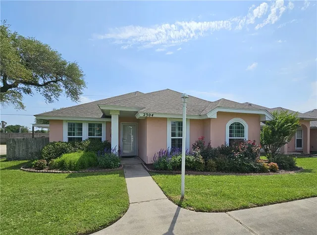 a front view of a house with garden