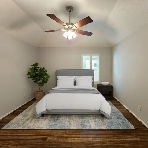 a white bed sitting in a bedroom next to a window and a chandelier