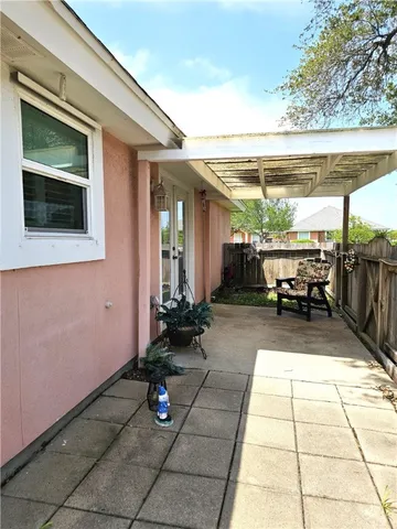 a view of a patio with table and chairs potted plants with wooden floor