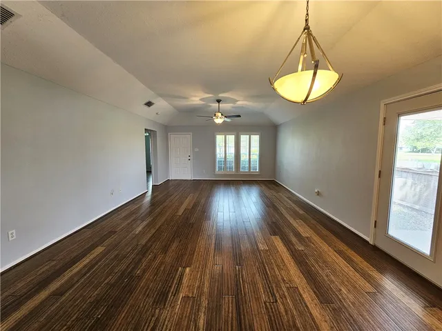 a view of a room with wooden floor and window