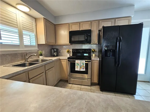 a kitchen with a refrigerator stove and sink