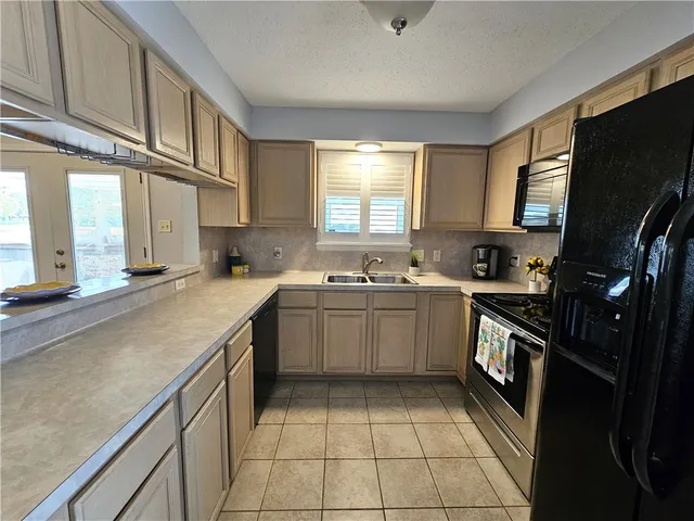 a kitchen with a sink window and cabinets
