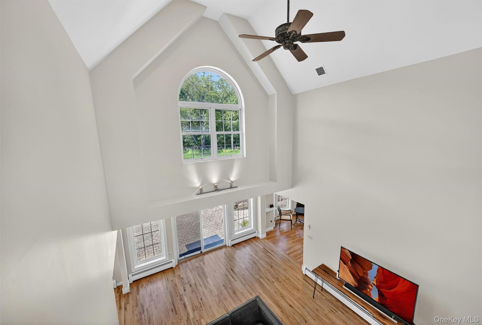 954 Ridgebury Road New Hampton, NY 10958 - Photo 28 of 45 From the 2nd floor landing, you can see how the living room feels grand and open, with soaring ceilings, tall windows, and a dramatic sense of light and space.