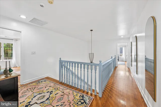 a spacious bedroom with a bed a mirror and desk