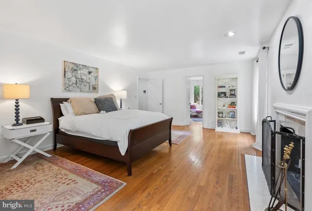 a bedroom with furniture and a large window