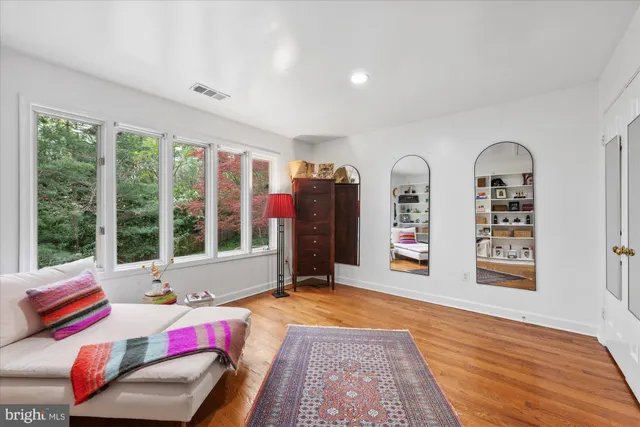 a spacious bathroom with a double vanity sink a mirror and a shower