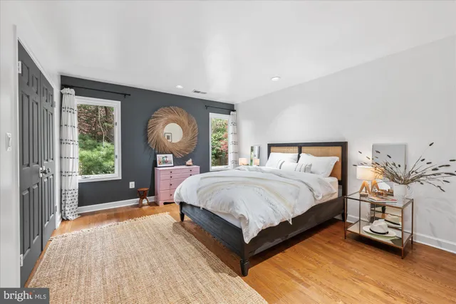 a bedroom with furniture and a large window