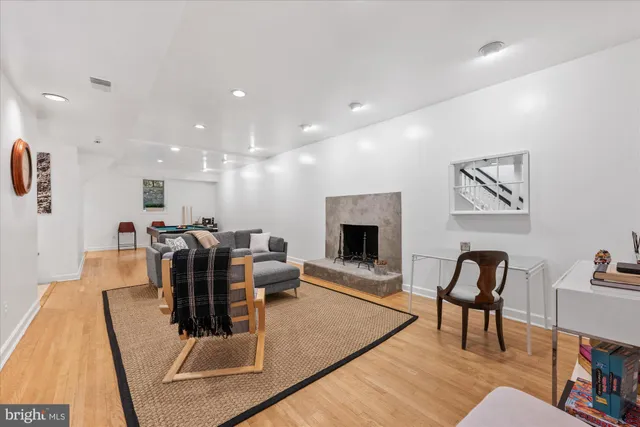 a room with wooden floor and pool table
