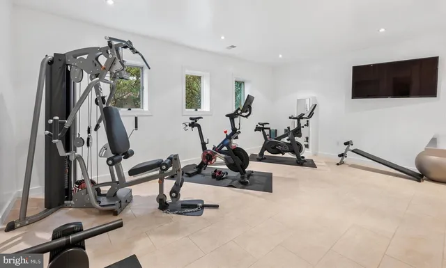a view of a chair and tables in the patio next to a yard