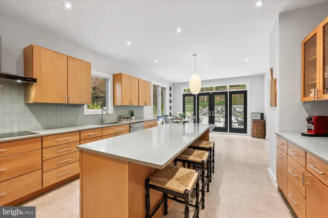 a kitchen with stainless steel appliances granite countertop a sink a stove and a refrigerator