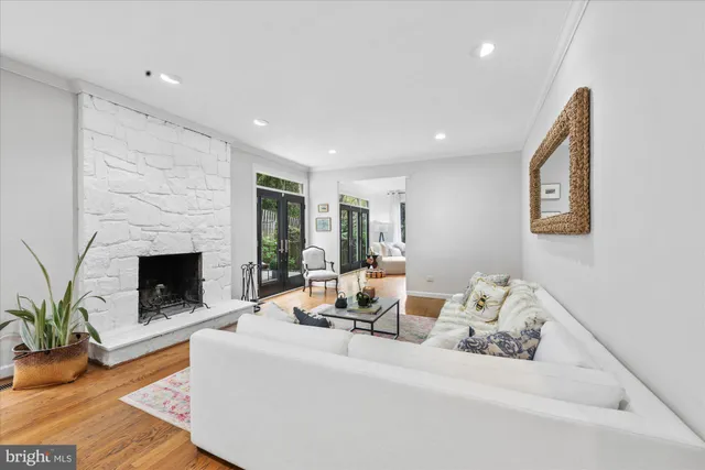 a living room with furniture large a fireplace