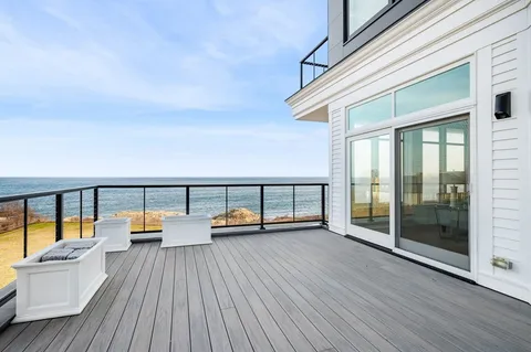 a view of a balcony with couch and wooden floor