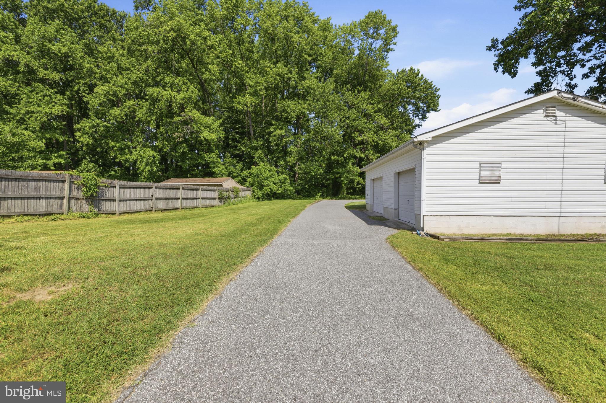 2411 Poplar Road Baltimore, MD 21221 - Photo 25 of 36 a view of a backyard with large trees