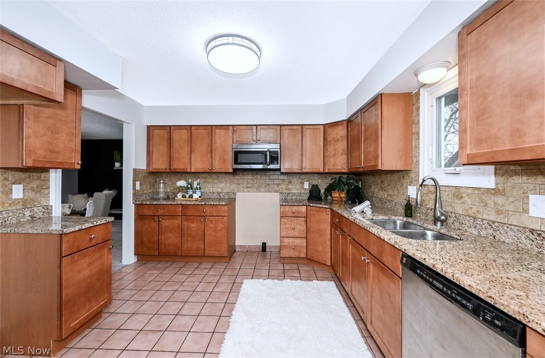 6151 Taylor Road Clinton, OH 44216 - Photo 16 of 49 *NICE KITCHEN W/GRANITE COUNTERTOPS, TILE BACKSPLASH, MAPLE CABINETS WITH SOFT CLOSE DRAWERS, SIDE PANTRY AREA, STAINLESS FAUCET ~