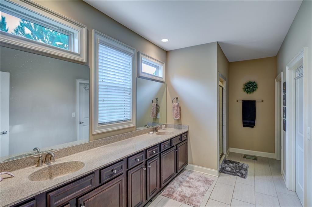 2443 Barrett Preserve Court Marietta, GA 30064 - Photo 15 of 46 a bathroom with a double vanity sink and a mirror