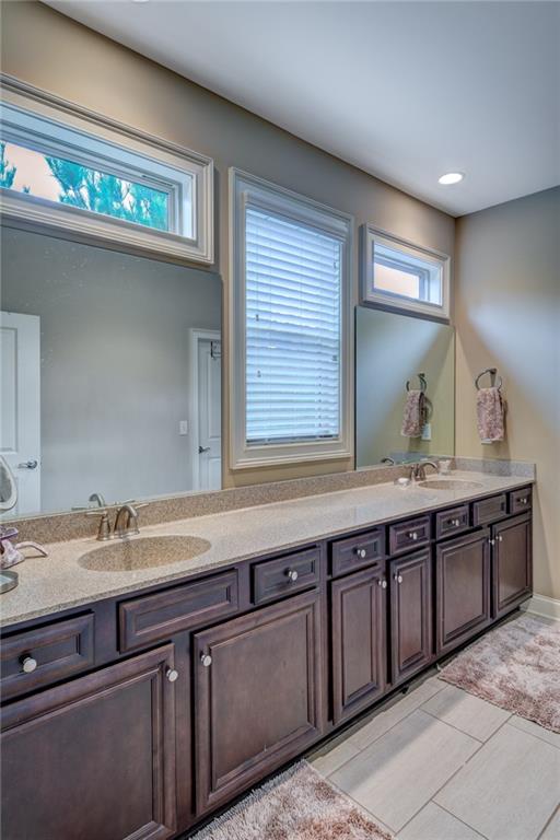 2443 Barrett Preserve Court Marietta, GA 30064 - Photo 16 of 46 a bathroom with double sink and a mirror