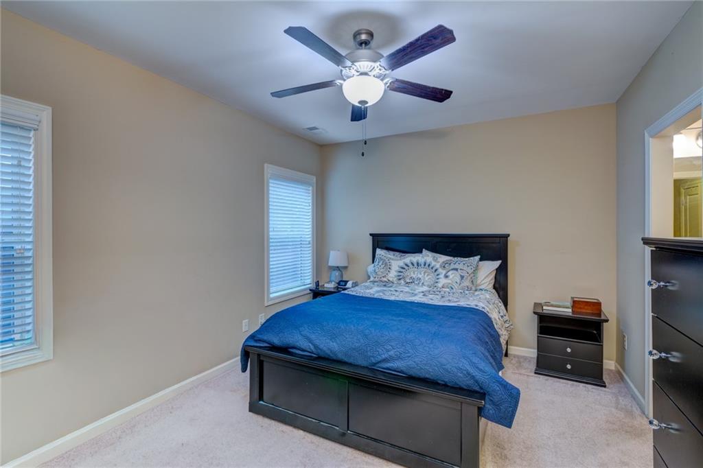 2443 Barrett Preserve Court Marietta, GA 30064 - Photo 24 of 46 a room with a bed and a ceiling fan