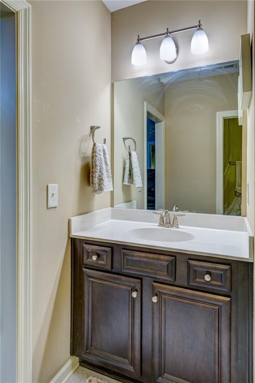 2443 Barrett Preserve Court Marietta, GA 30064 - Photo 26 of 46 a view of a sink a mirror and wooden floor