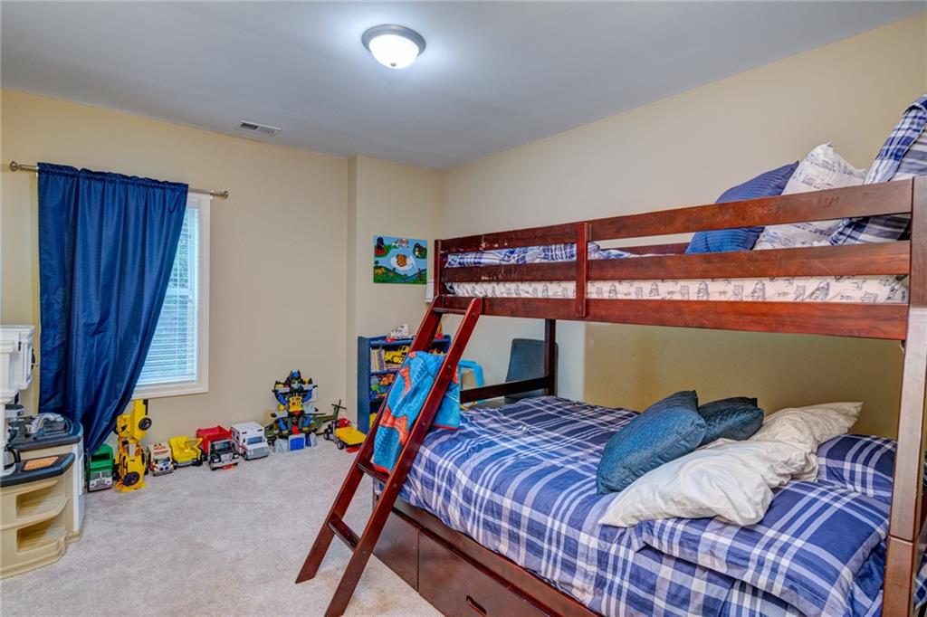 2443 Barrett Preserve Court Marietta, GA 30064 - Photo 27 of 46 a bed room with a bed and a ceiling fan