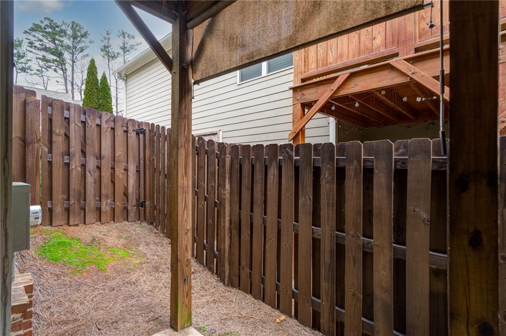 2443 Barrett Preserve Court Marietta, GA 30064 - Photo 32 of 46 a view of a house with a backyard and wooden fence