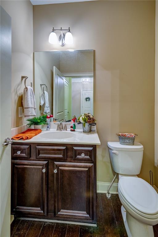 2443 Barrett Preserve Court Marietta, GA 30064 - Photo 36 of 46 a bathroom with a toilet a sink and a mirror