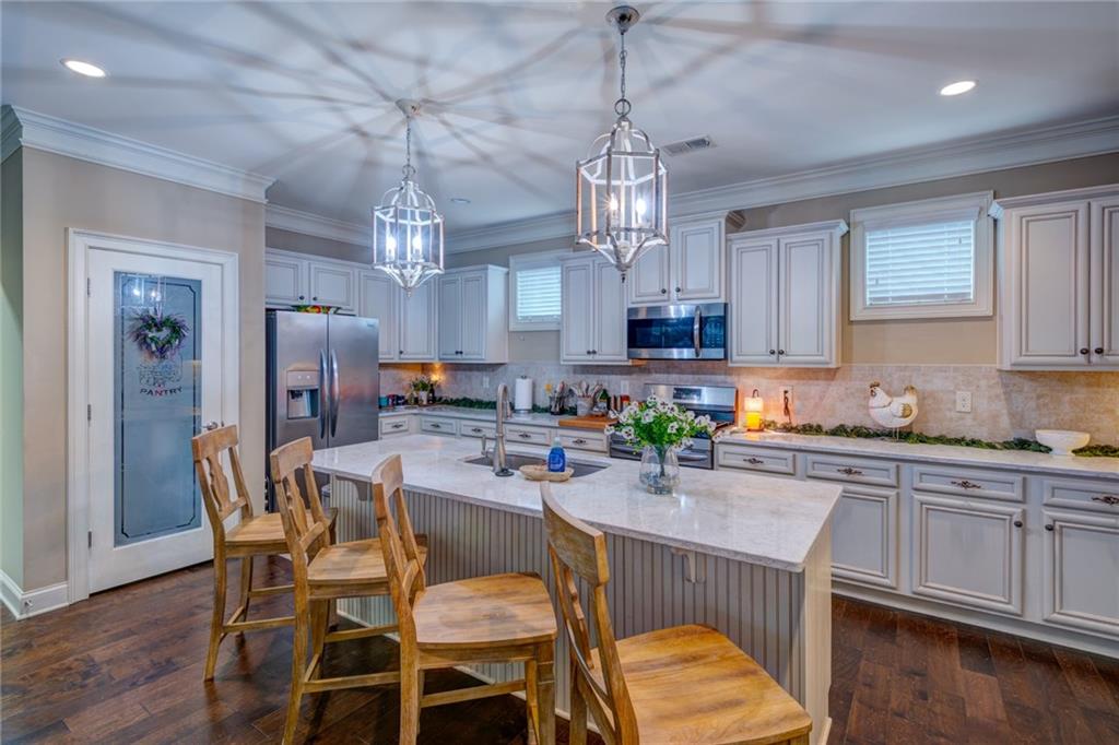 2443 Barrett Preserve Court Marietta, GA 30064 - Photo 6 of 46 a view of a dining room with furniture a chandelier and wooden floor