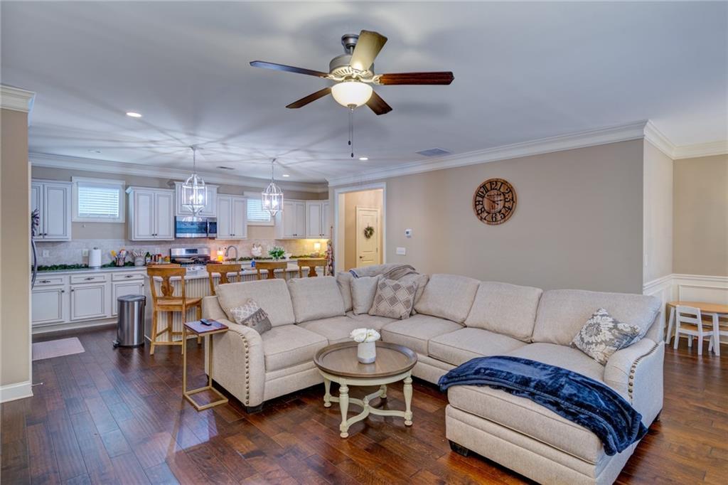 2443 Barrett Preserve Court Marietta, GA 30064 - Photo 10 of 46 a living room with furniture kitchen view and a chandelier