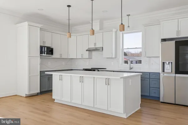 a kitchen with kitchen island white cabinets and white appliances