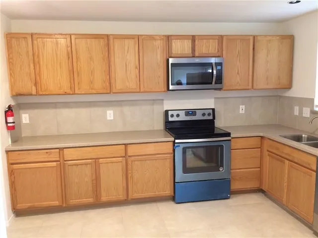 a kitchen with a sink and a microwave