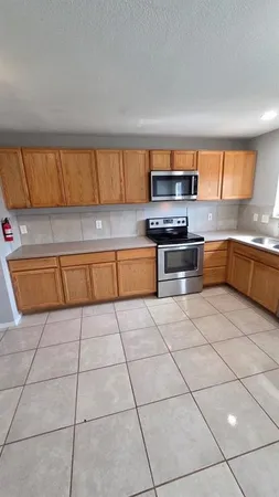 a kitchen with stainless steel appliances granite countertop a sink and cabinets
