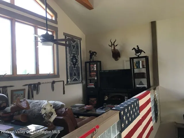 a bedroom with a bed and a flat tv screen on the dresser
