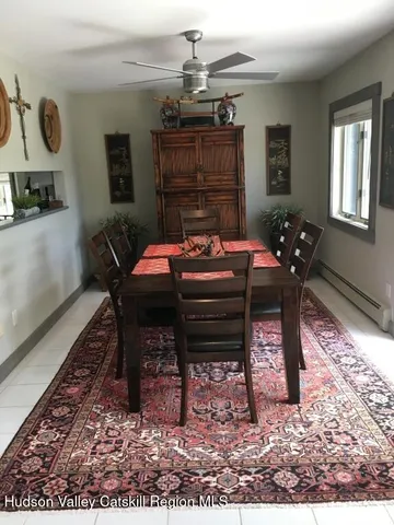 a living room with furniture a chandelier and a rug