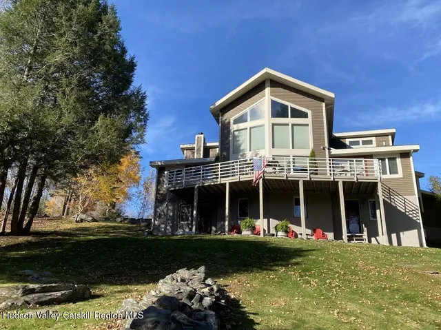 a front view of a house with a garden and yard