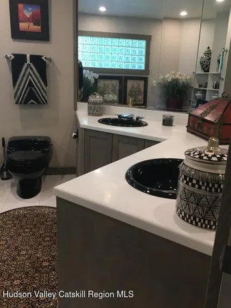 a kitchen with kitchen island stainless steel appliances a sink a stove and a refrigerator