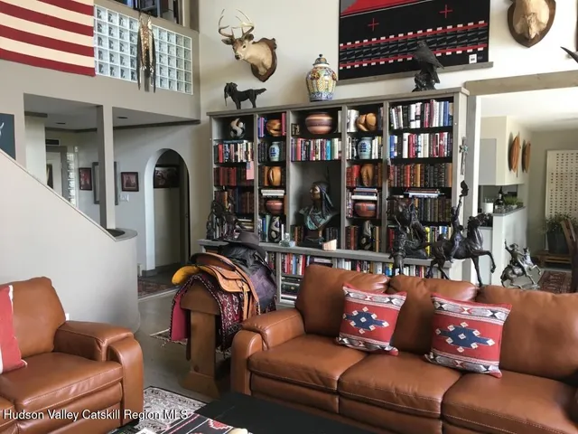 a outdoor living area with furniture a table and a book shelf