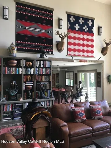 a living room with furniture a rug and a table