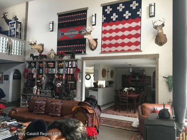 a living room with furniture and a floor to ceiling window